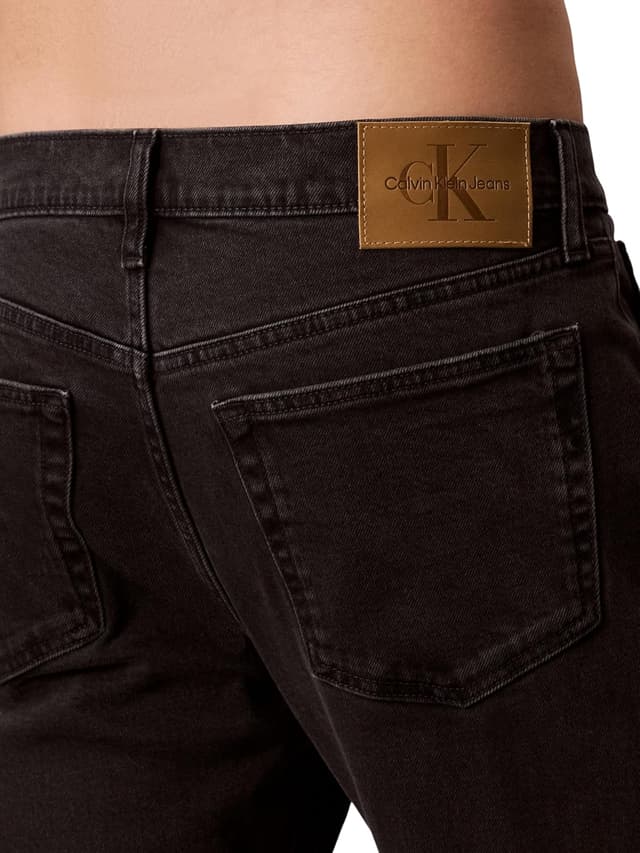 Detalle de Calvin Klein Men’s Black Oil Slick Slim Tapered Fit Jeans