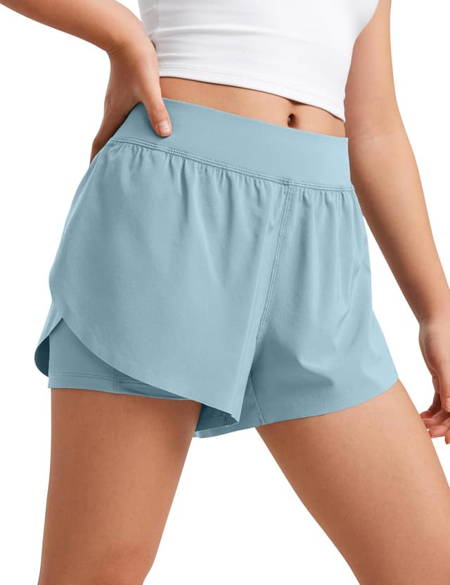 Detalle de CRZ YOGA ragazze 2 in 1 delfino: pantaloncini con tasche, spandex incorporato e tessuto ad asciugatura rapida
