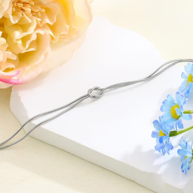 Detalle 1 de HEYEJET Liebesknoten Armband aus Edelstahl (Silber/Gold) – Geschenkidee mit Verlängerungskette