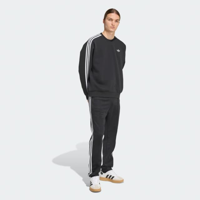Detalle de Sudadera de cuello redondo holgada Adicolor 3 Stripes de adidas en negro