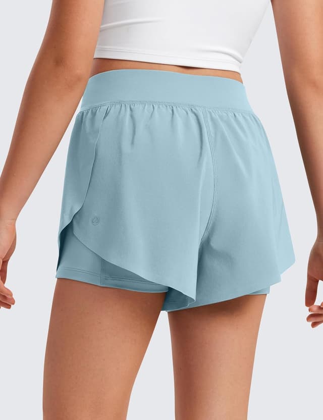 Detalle de CRZ YOGA ragazze 2 in 1 delfino: pantaloncini con tasche, spandex incorporato e tessuto ad asciugatura rapida