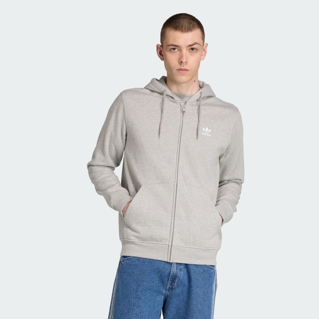 Detalle de Chaqueta con capucha Trefoil Essentials de Adidas: versatilidad y estilo en gris