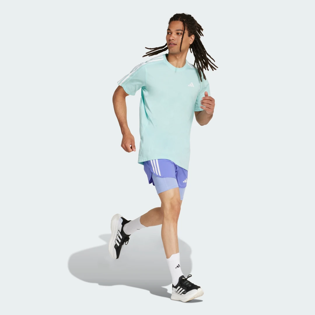 Detalle de Pantalón corto Own the Run 2-in-1 3 bandas de Adidas – azul