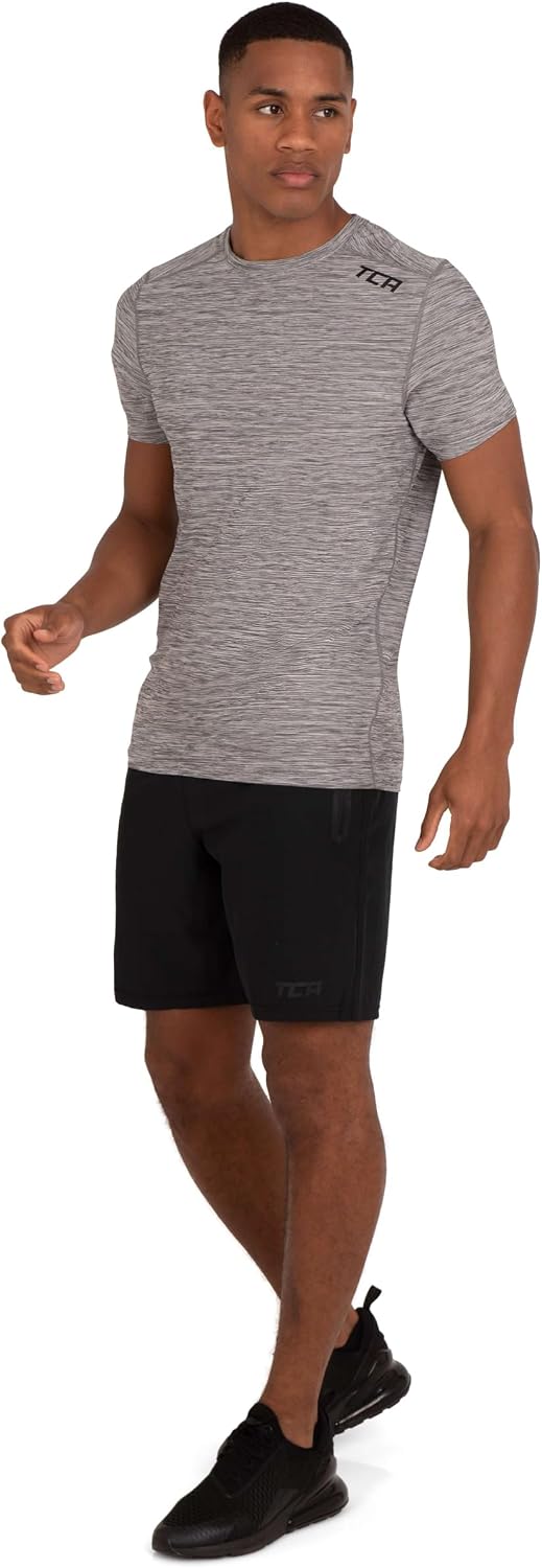 Detalle de TCA T-Shirt de Sport à Manches Courtes pour Homme – Technologie D.R.Y., coupe ajustée, motif Galaxy
