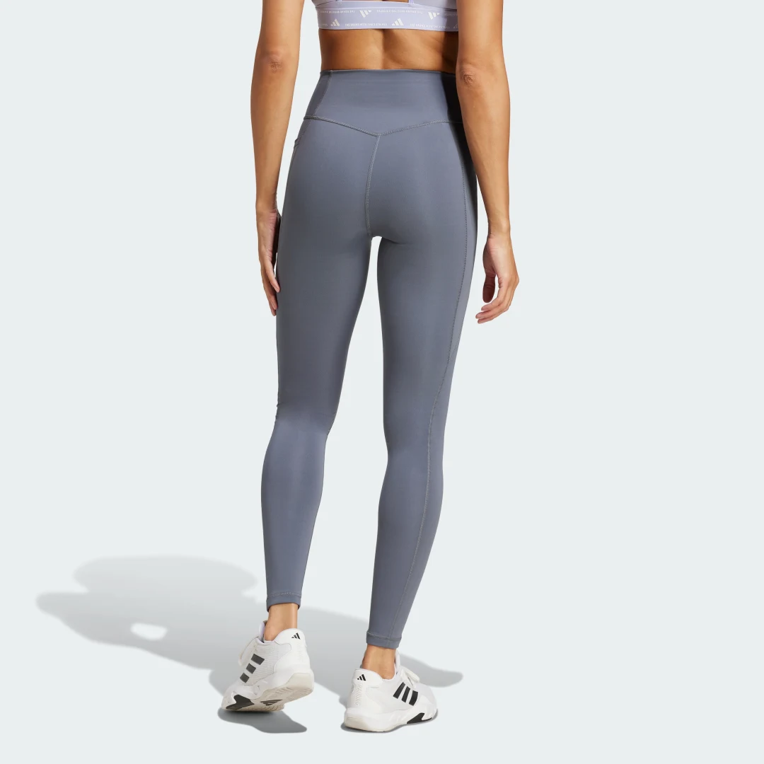 Detalle de Mallas largas con bolsillo oculto Optimé Essentials de Adidas – estilo práctico para tus entrenamientos