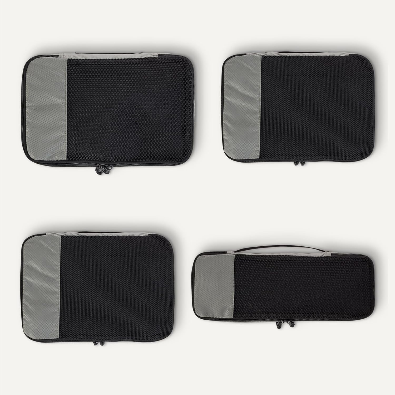 Detalle de Amazon Essentials juego de 4 cubos para viaje con doble cremallera y panel de malla (gris)