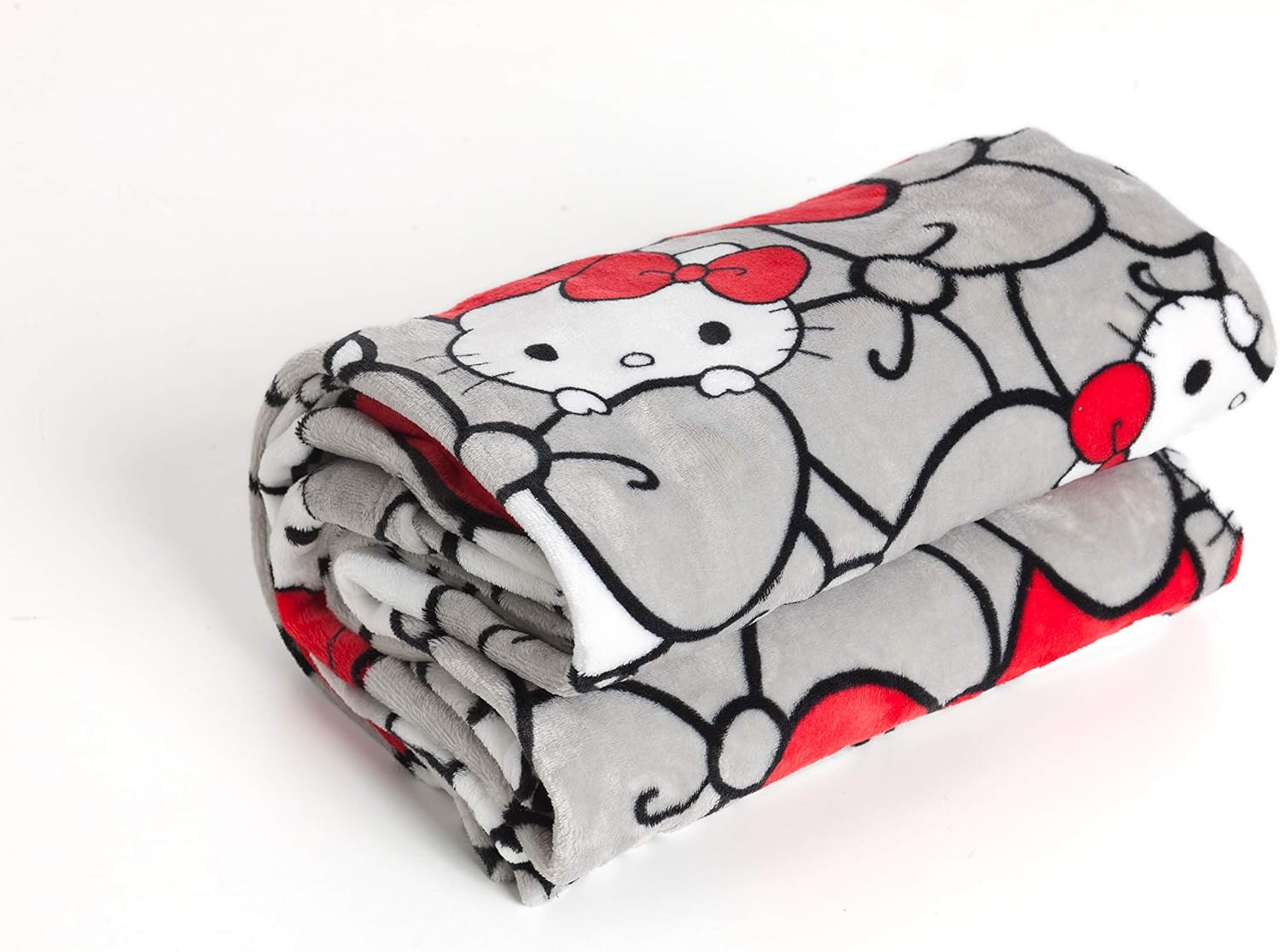 Detalle 2 de Kanguru Deluxe Hello Kitty – koc z rękawami, kieszenią i różową kratką, 140 × 180 cm