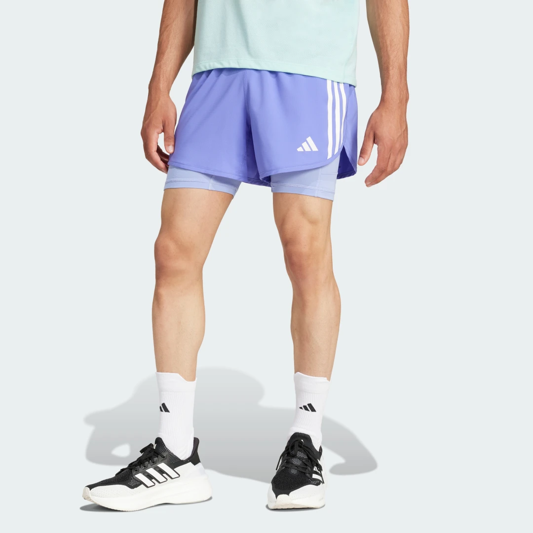 Detalle de Pantalón corto Own the Run 2-in-1 3 bandas de Adidas – azul