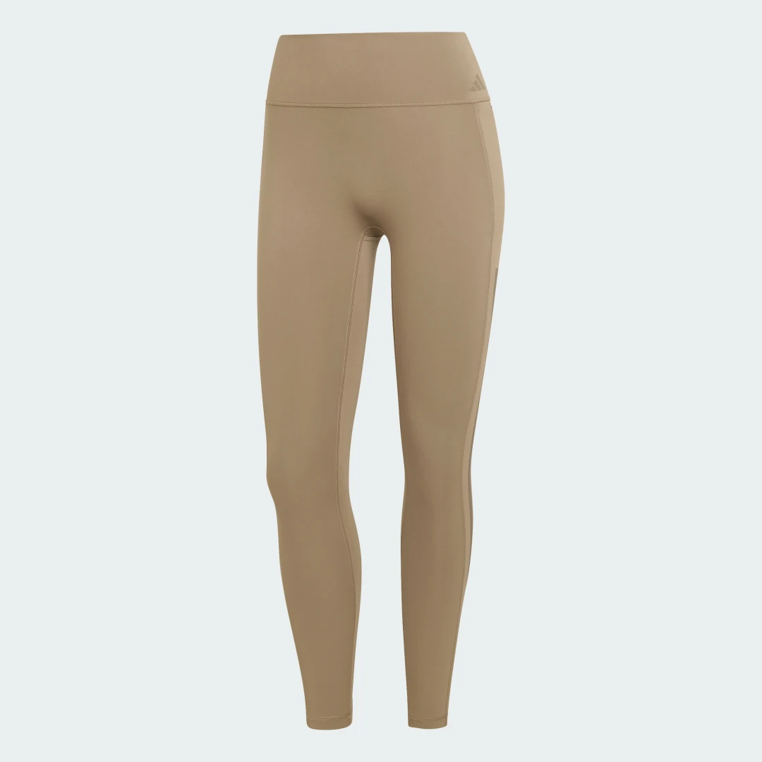 Detalle de Mallas de entrenamiento 7/8 Optime 3 Stripes de Adidas — uso práctico, estilo y comodidad en beige