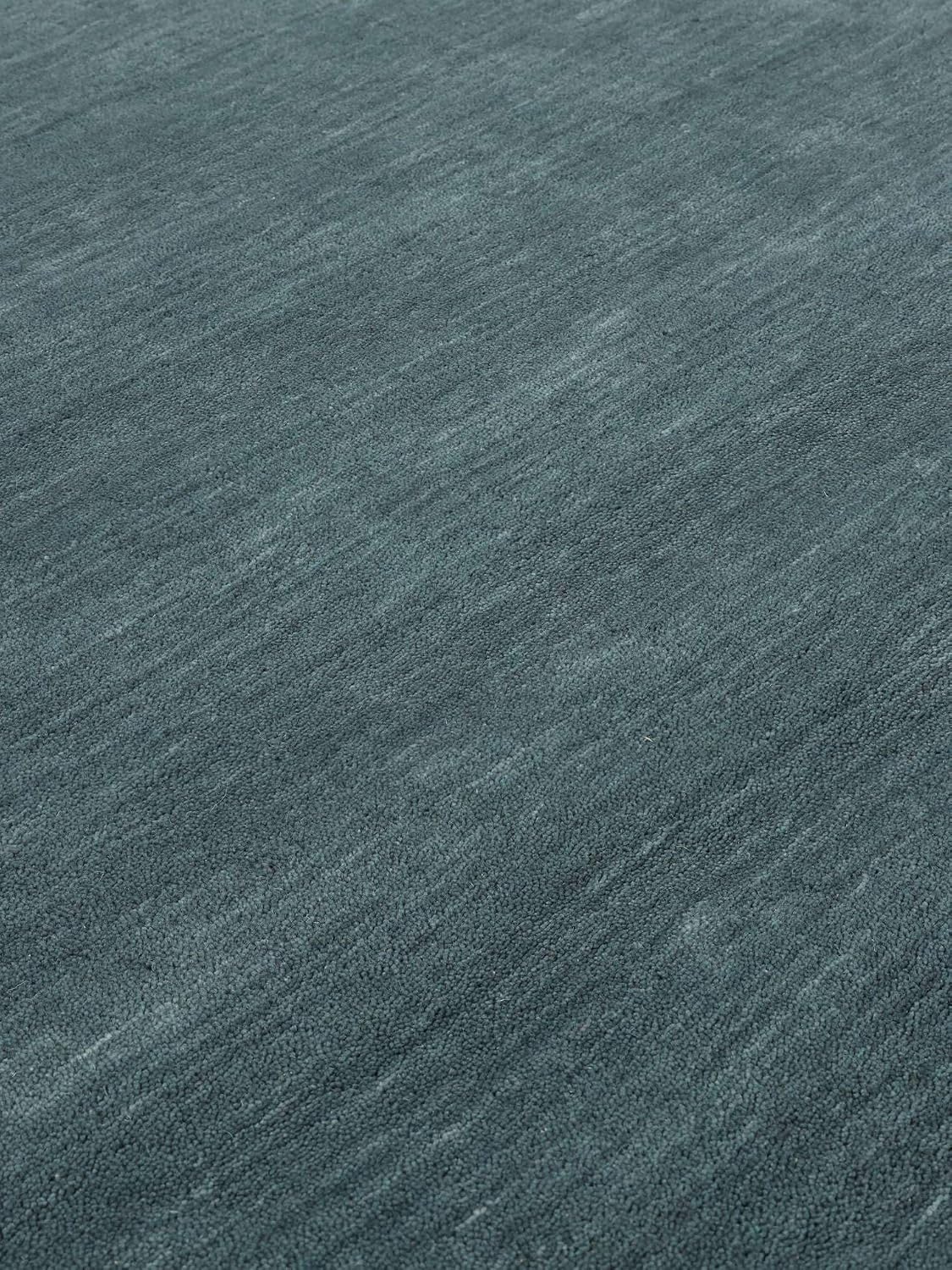 Detalle 1 de RugVista Handloom wollen rond vloerkleed Ø 150 cm, petrolblauw en handgemaakt