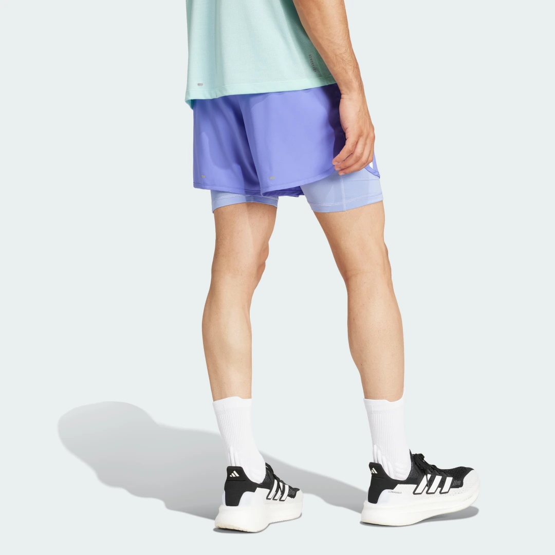 Detalle de Pantalón corto Own the Run 2-in-1 3 bandas de Adidas – azul