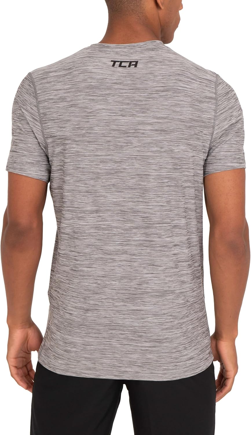 Detalle de TCA T-Shirt de Sport à Manches Courtes pour Homme – Technologie D.R.Y., coupe ajustée, motif Galaxy